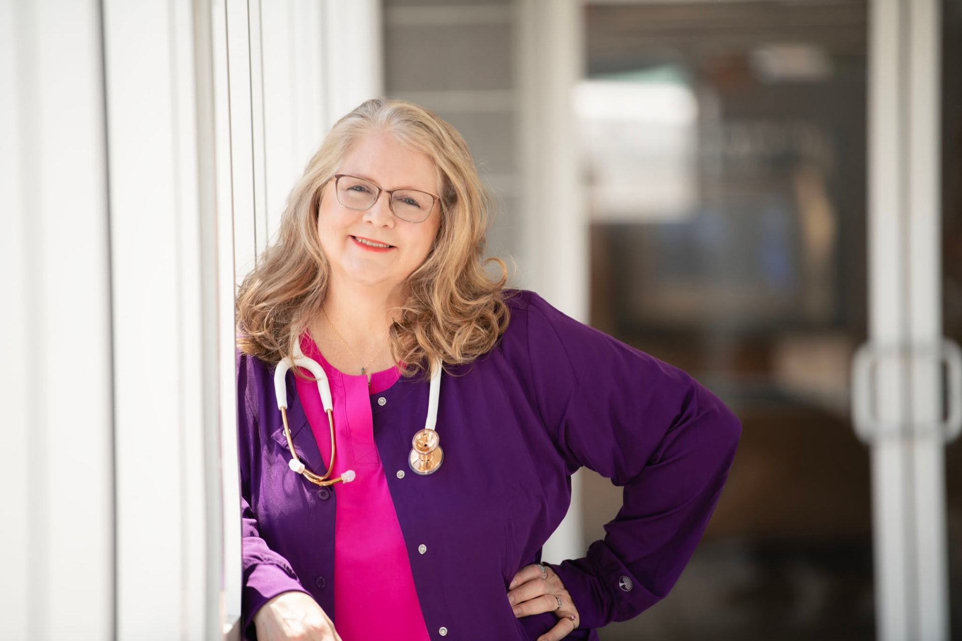 Mary Hill, RN in purple scrubs with a stethoscope